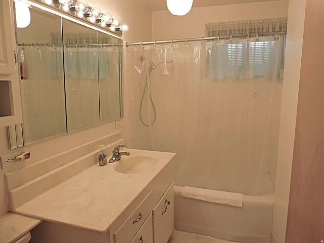 Vanity with integrated sink, chrome-finish faucet, and built-in medicine cabinet
