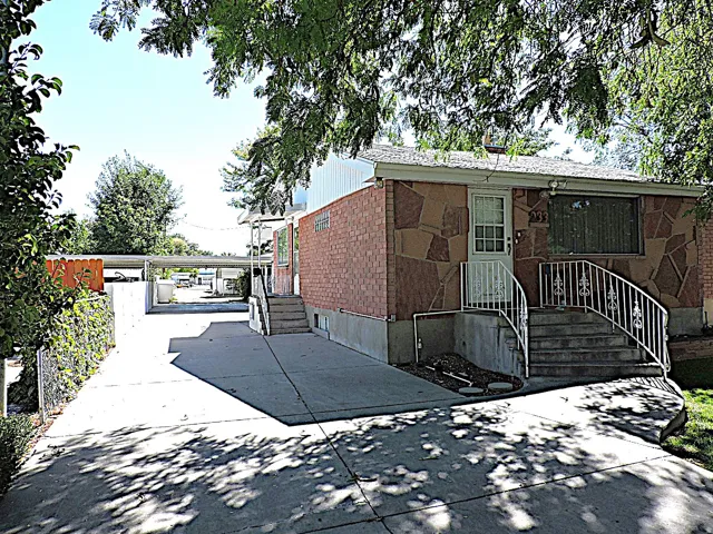 Stone and brick veneer exterior with a concrete driveway