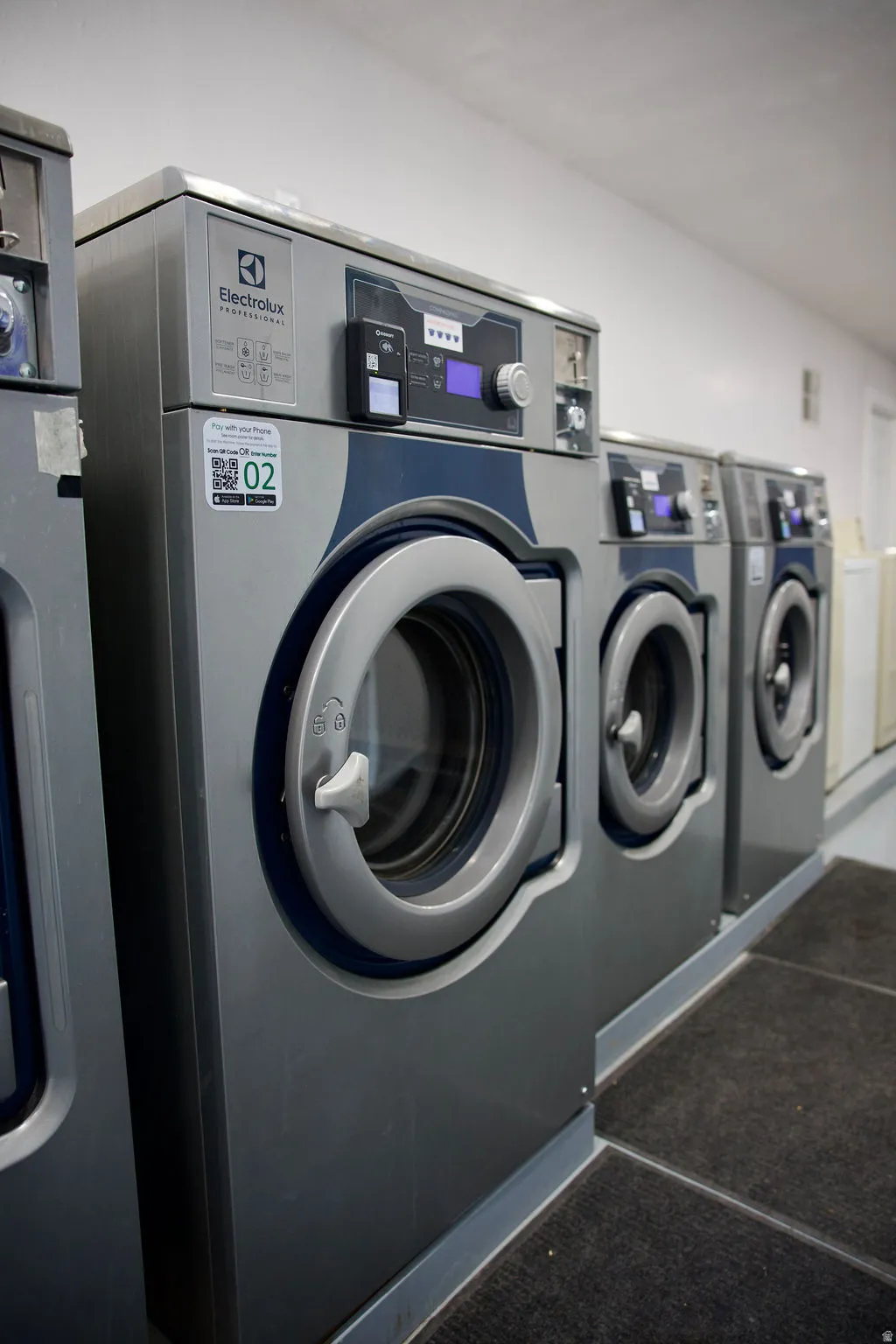 Multiple front-loading washing machines with digital displays