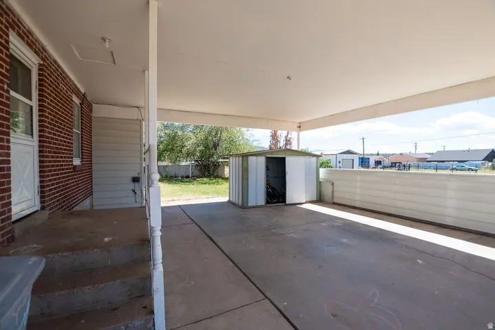 Covered concrete patio with direct backyard access