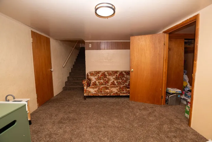 Carpeted flooring with a fixed ceiling light fixture
