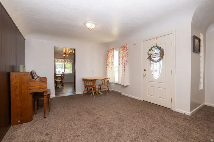 Neutral color palette throughout, featuring carpeted flooring and white walls