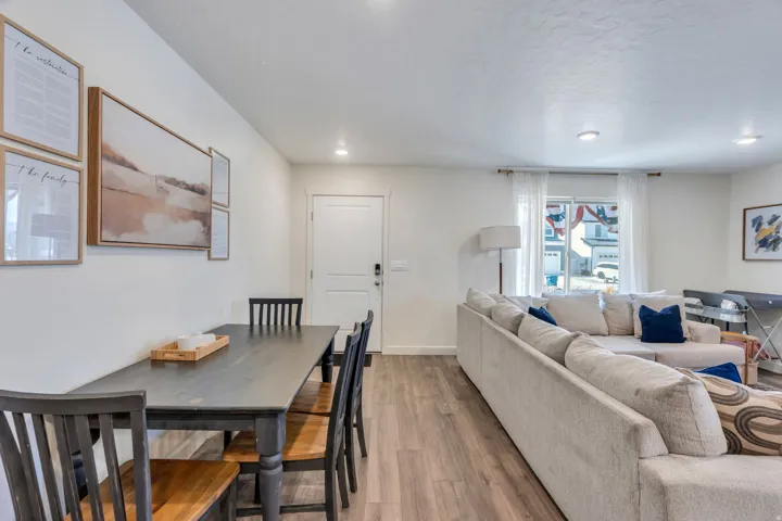 Wood-finish flooring throughout, recessed lighting, and white walls create a bright interior