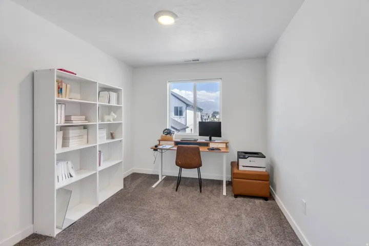 Recessed ceiling lighting, large window, and carpeted flooring
