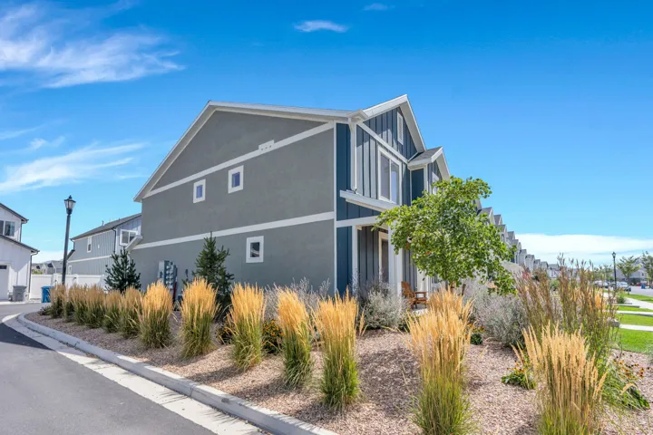 Multi-story exterior with a combination of stucco and vertical siding