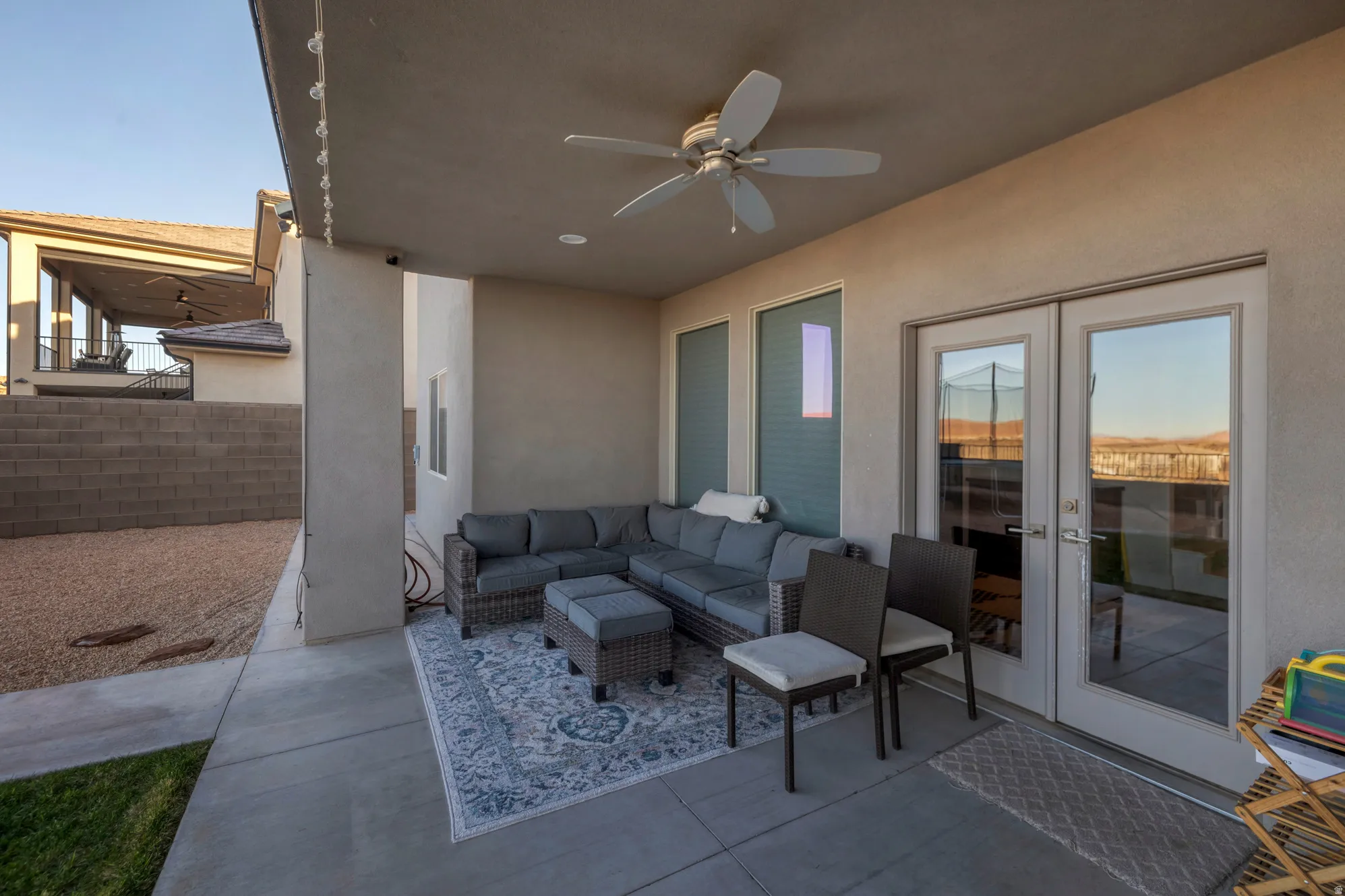 Covered patio featuring a ceiling fan, recessed lighting, concrete flooring, and double glass French doors