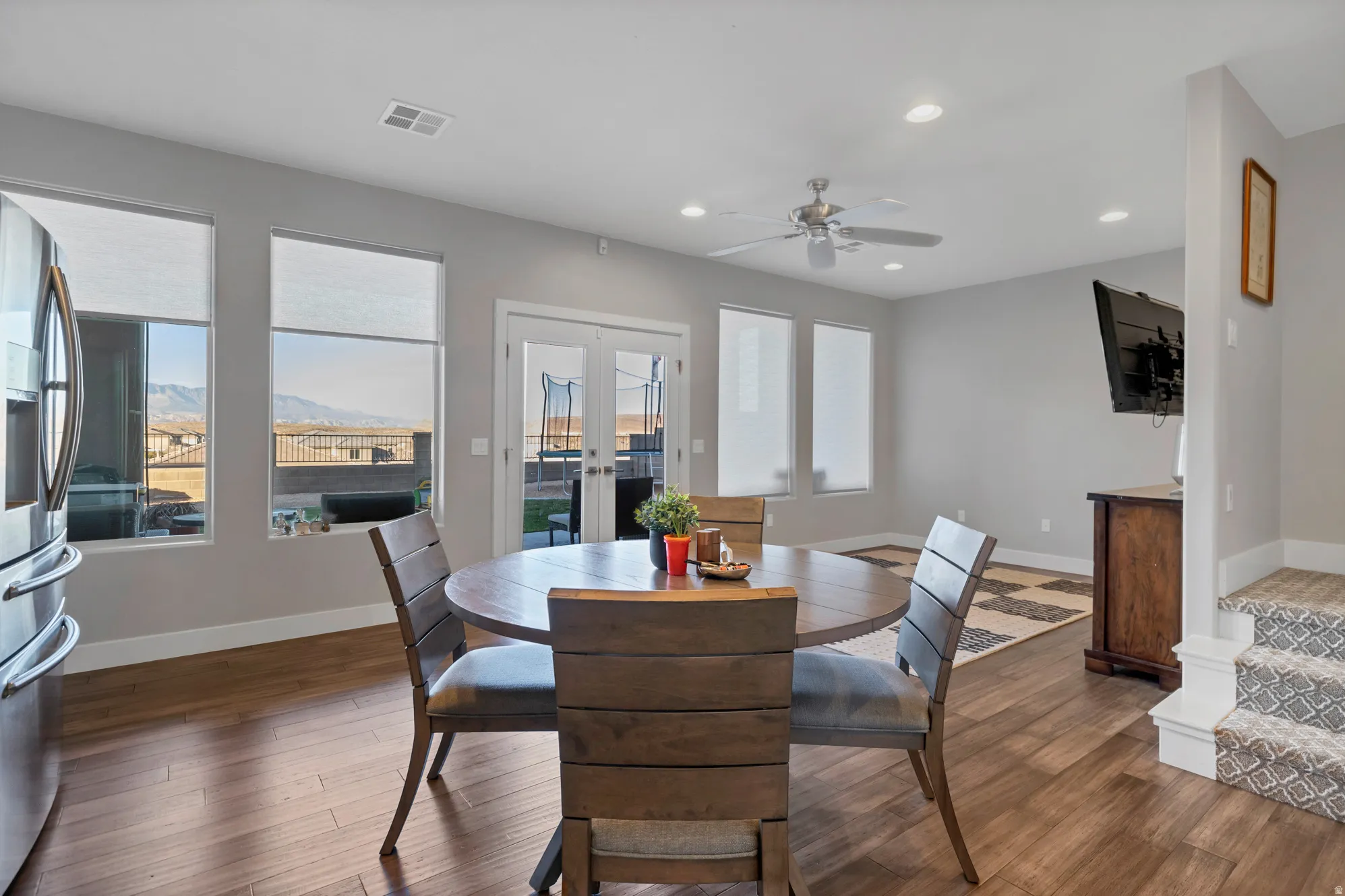 Recessed lighting, wood-finish flooring, ceiling fan, French doors, and ample natural light