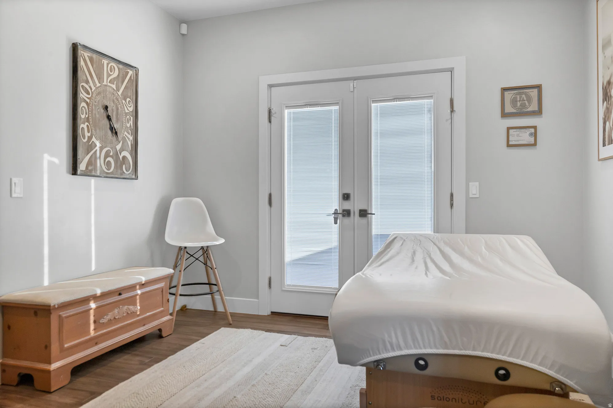 Hardwood-finish flooring, light gray wall color, and double glass-panel doors