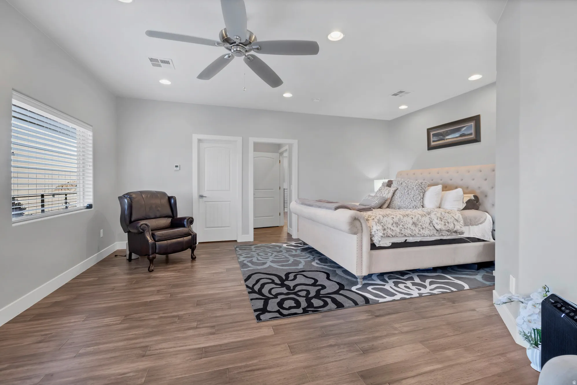 Wood-finish flooring throughout, recessed lighting, and a ceiling fan