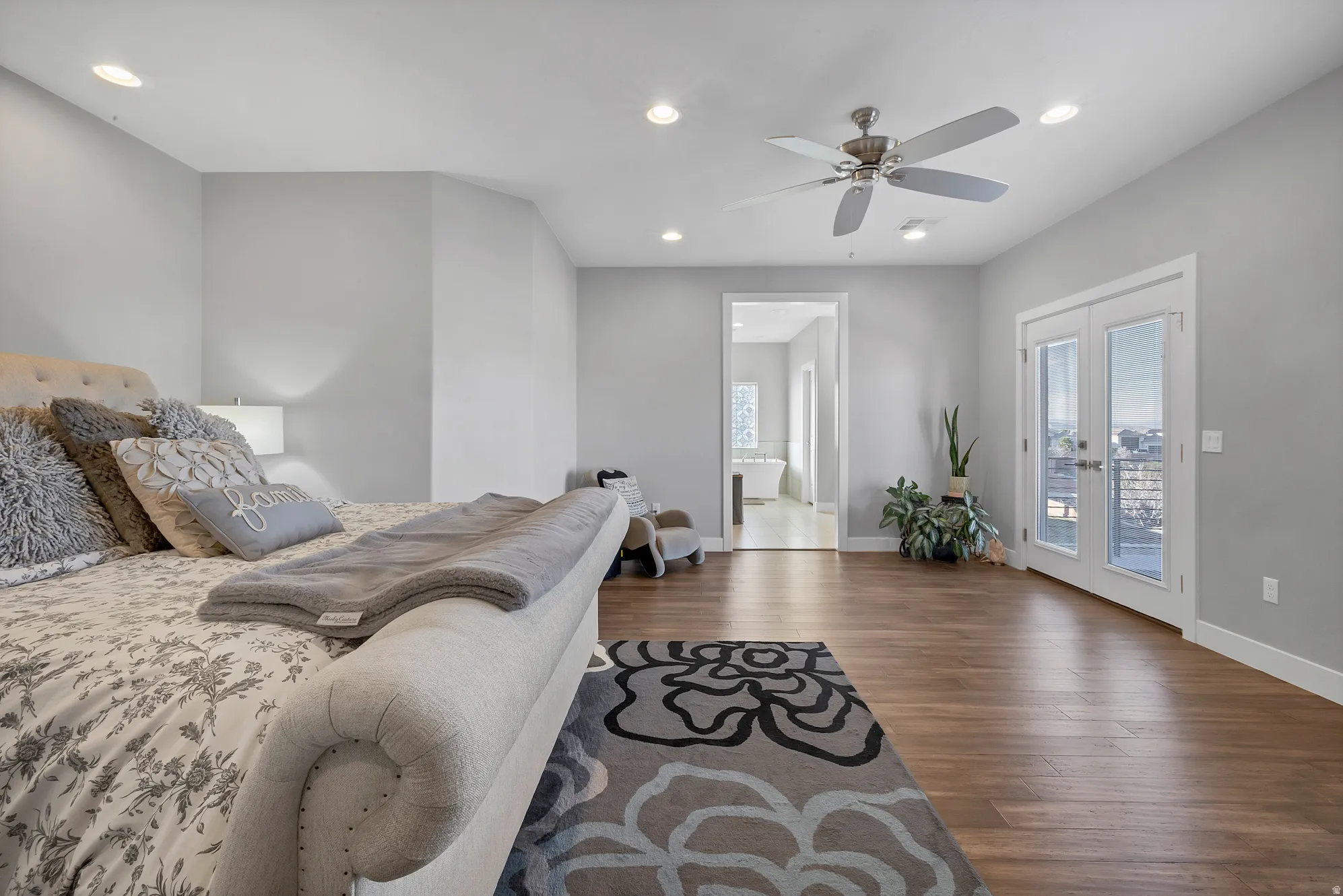 Wood-finish flooring, recessed lighting, and a ceiling fan with brushed nickel accents