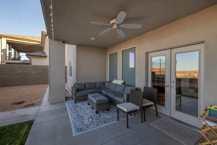 Covered patio featuring a ceiling fan, recessed lighting, concrete flooring, and double glass French doors