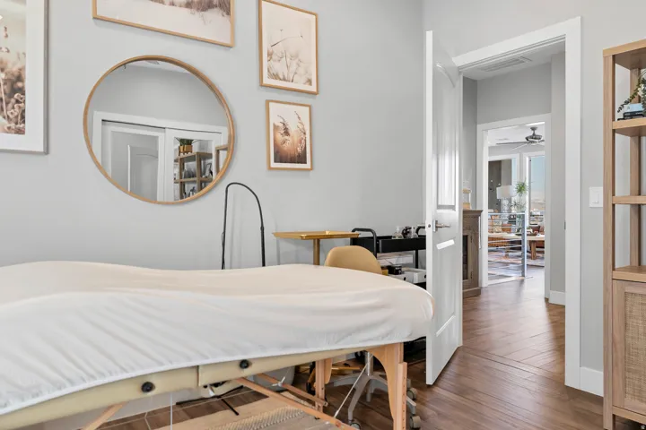 Wood-finish flooring with herringbone pattern, crisp white trim, and light gray wall paint