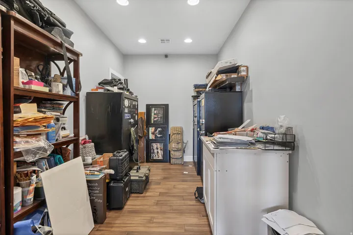 Wood-finish flooring, recessed lighting, and light grey wall paint