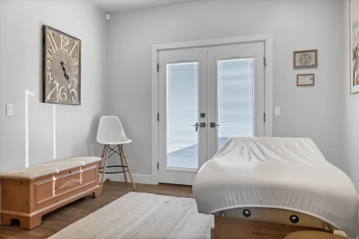 Hardwood-finish flooring, light gray wall color, and double glass-panel doors