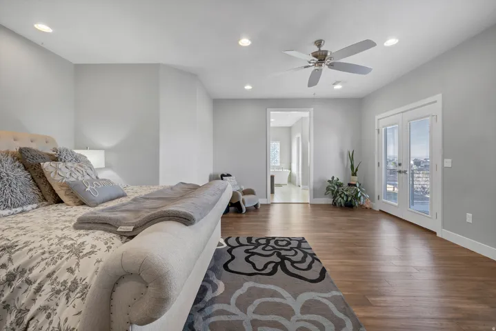 Wood-finish flooring, recessed lighting, and a ceiling fan with brushed nickel accents