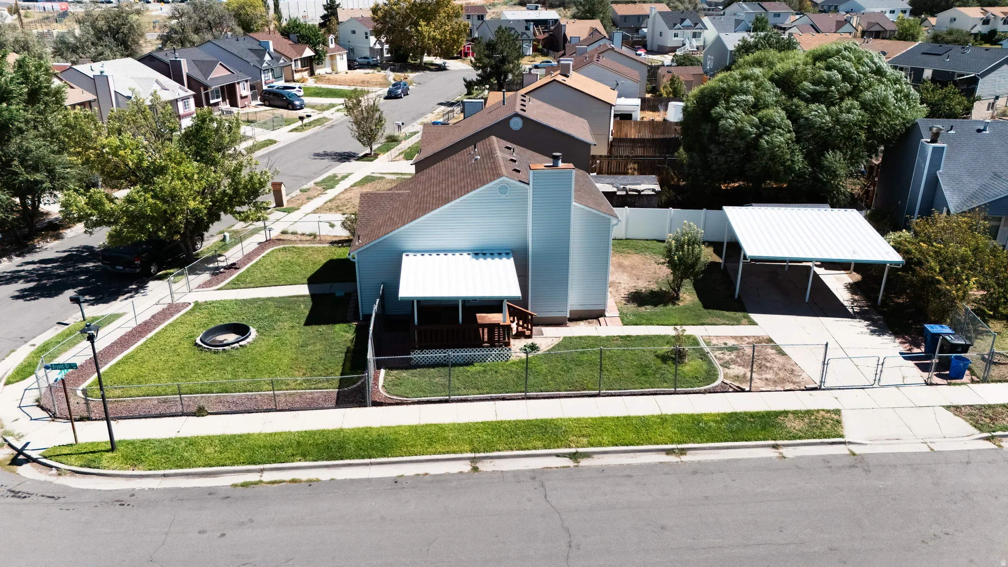 Corner lot property featuring a fenced lawn, and covered patio