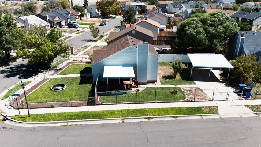 Corner lot property featuring a fenced lawn, and covered patio