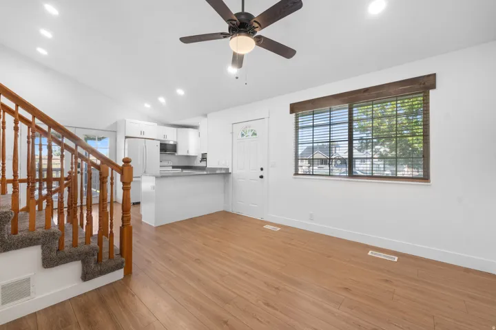 Open-concept living area with Laminate flooring, recessed lighting, and a ceiling fan