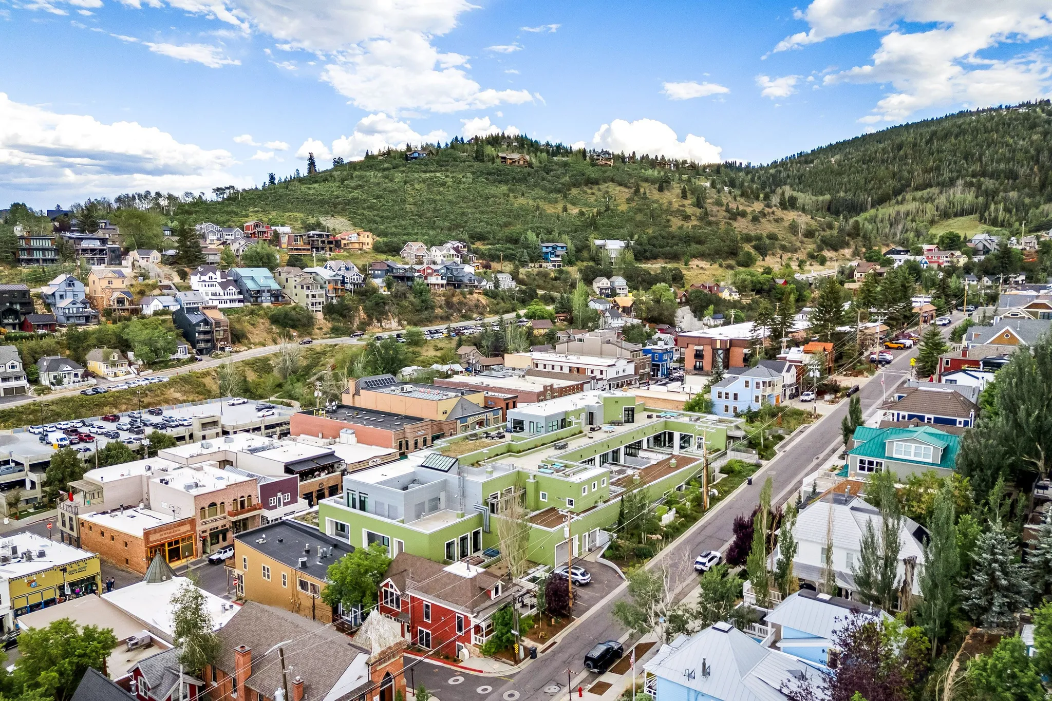 Aerial perspective showcasing a vibrant community nestled among verdant hillsides