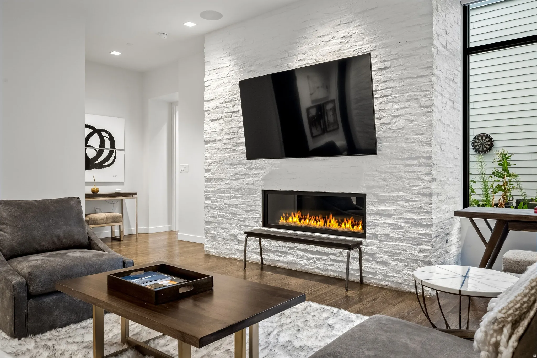 Stacked stone fireplace feature with an integrated linear firebox