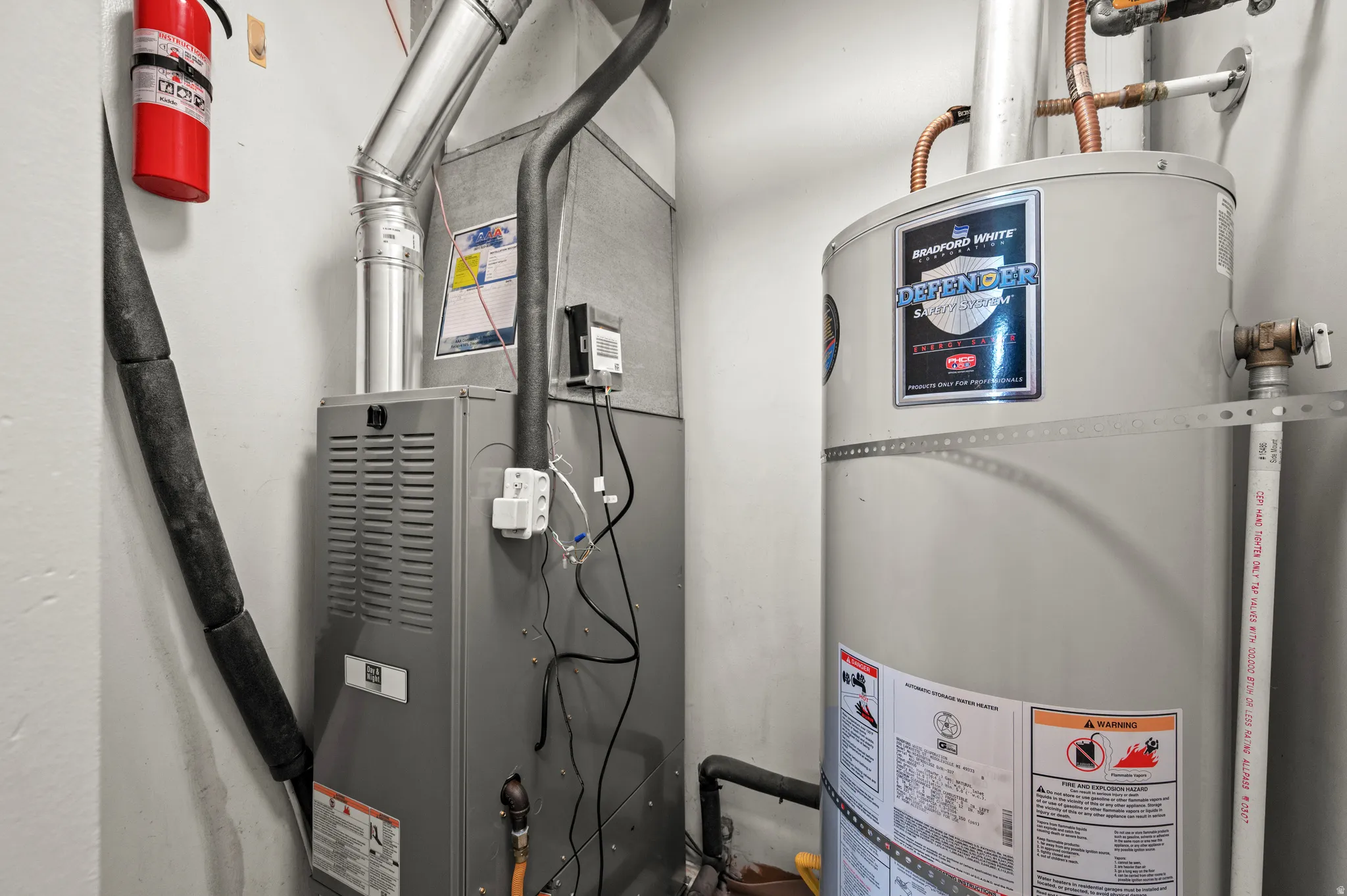 Forced air furnace and tank-style water heater