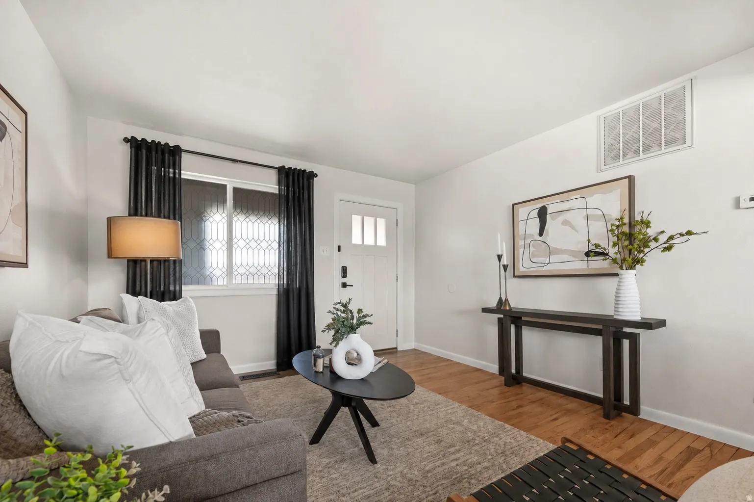 White paneled entry door with transom window