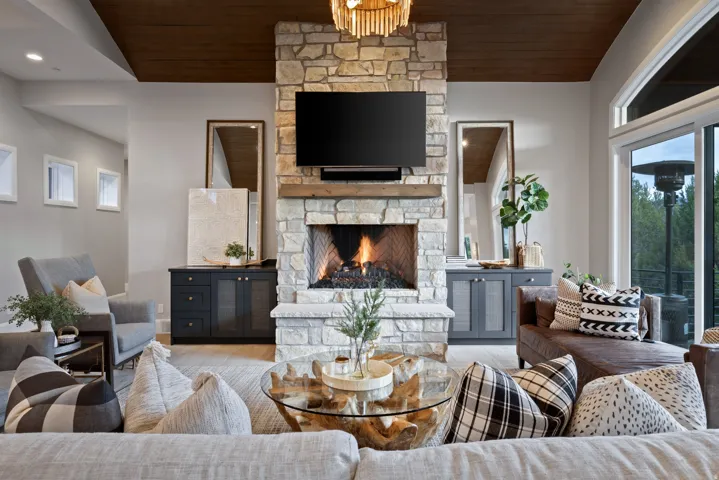 Stacked stone fireplace with a substantial hearth and wood mantel