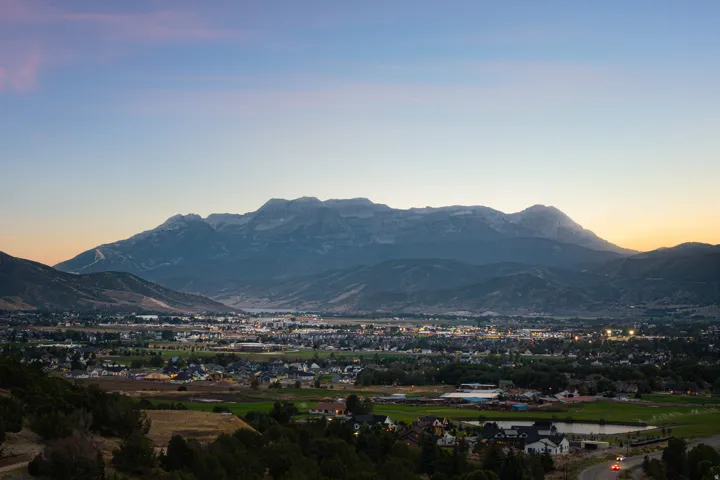 Expansive mountain range backdrop with a valley community below