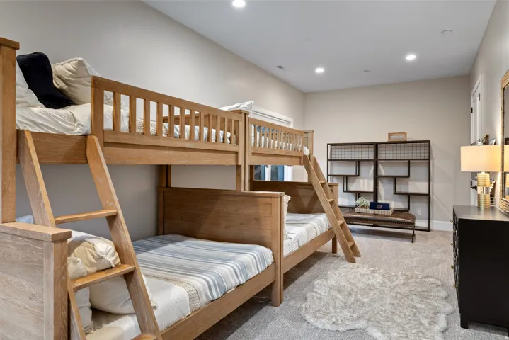 Recessed ceiling lighting, light neutral wall paint, and gray textured carpeting
