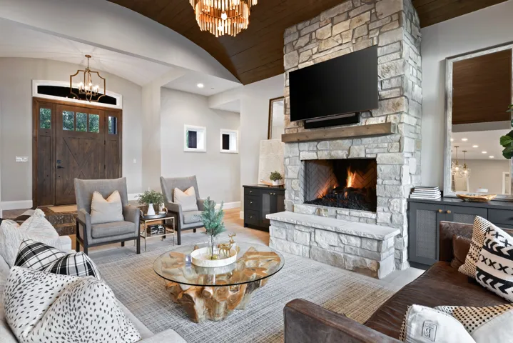 Stone-clad fireplace with wood mantle and hearth bench