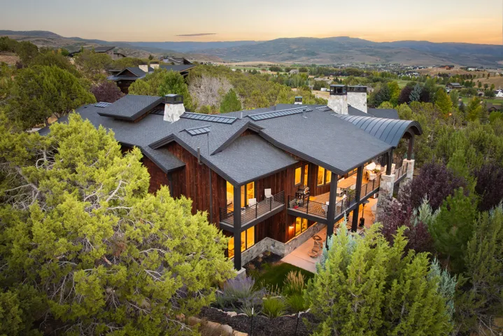 Multi-level residence featuring wood siding and stone accents