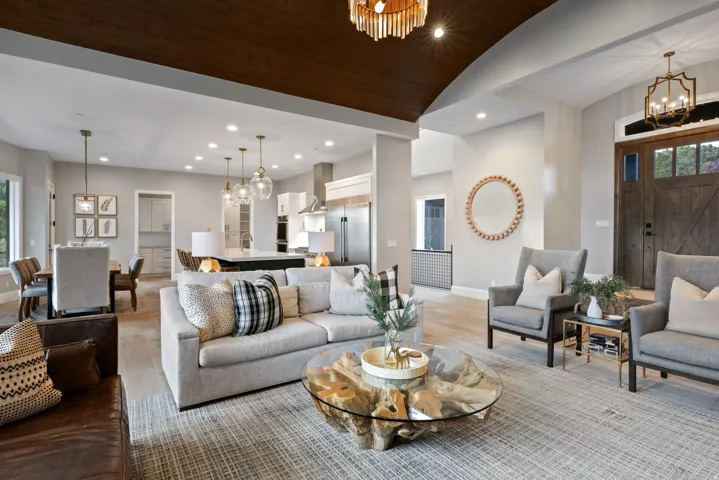 Vaulted wood-paneled ceiling, recessed lighting, wood-finish flooring, and a barn-door style entry