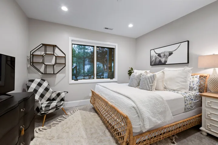 Recessed ceiling lighting, a framed window, light-toned wall paint, and carpeted flooring