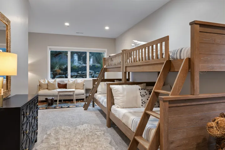 Window with exterior rock landscaping, carpeted flooring, and recessed lighting