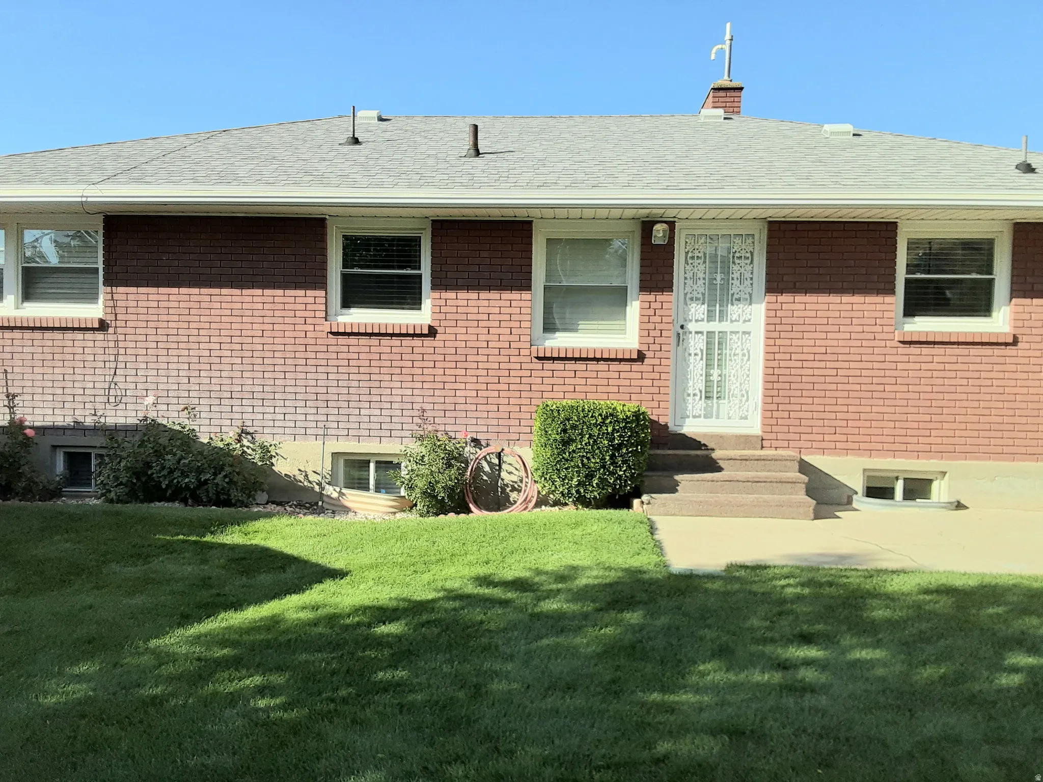 Back of home in backyard - Brick Home
