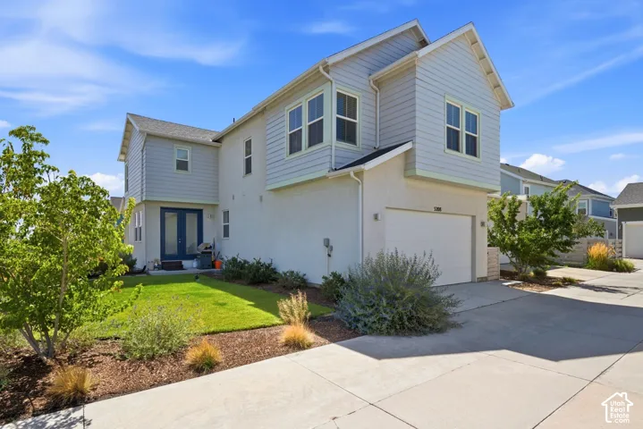 Two-story residence featuring blue siding and stucco exterior