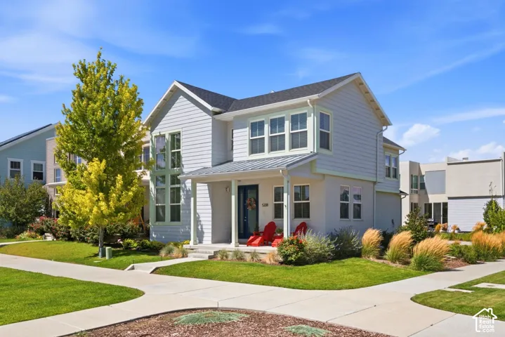 Charming two-story colonial with crisp white siding and gabled roofline