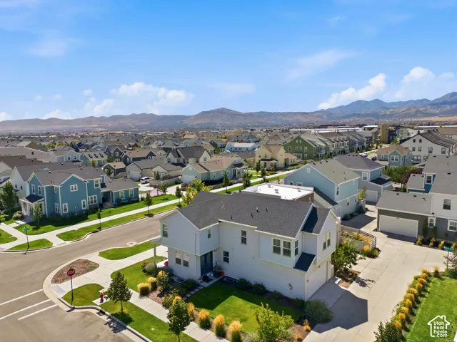 Contemporary-style residence with a two-car garage, mature landscaping, and a paved driveway