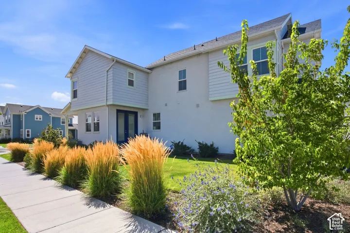 Contemporary exterior with light siding and stucco accents