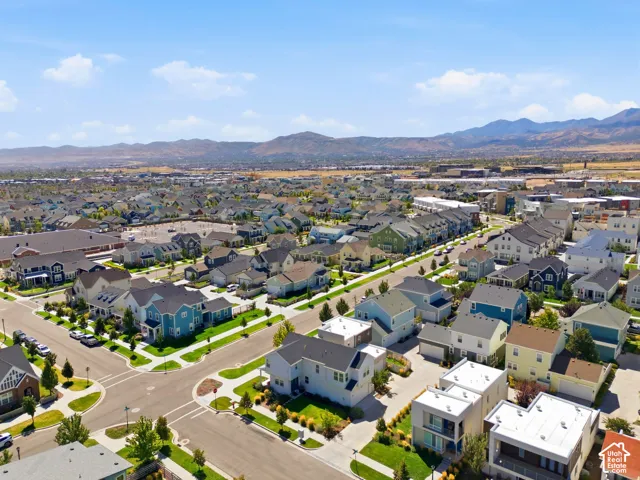 Residential community with varied architectural styles and established landscaping, surrounded by distant mountain ranges