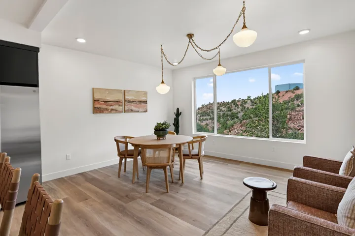 Expansive window with a scenic backdrop, recessed lighting, wood-finish flooring, and white painted walls