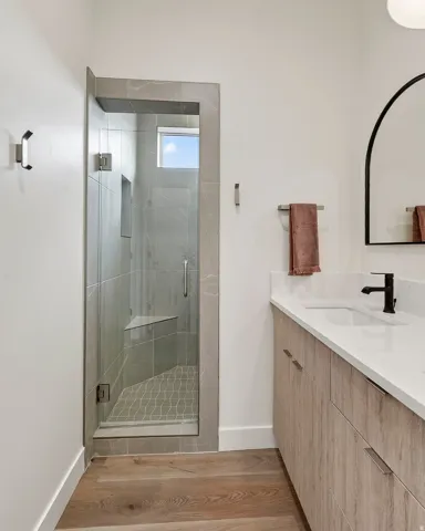 Walk-in shower with a built-in bench and patterned floor tile