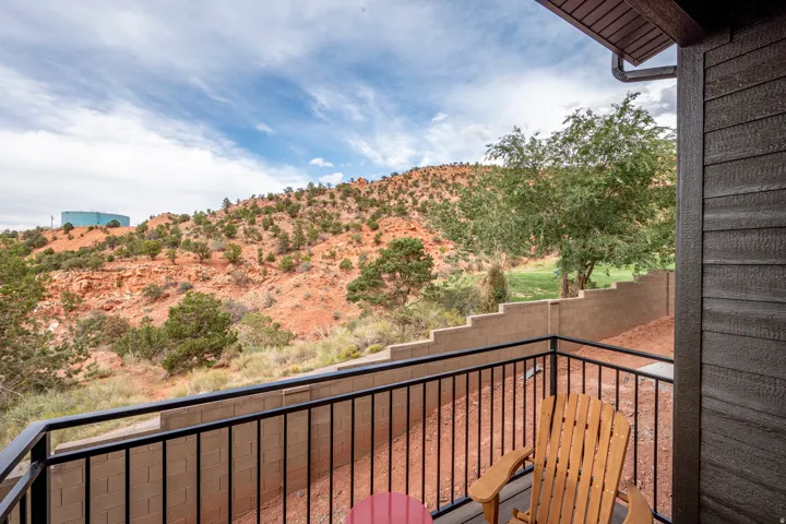 Balcony with black metal railing, offering expansive desert landscape views