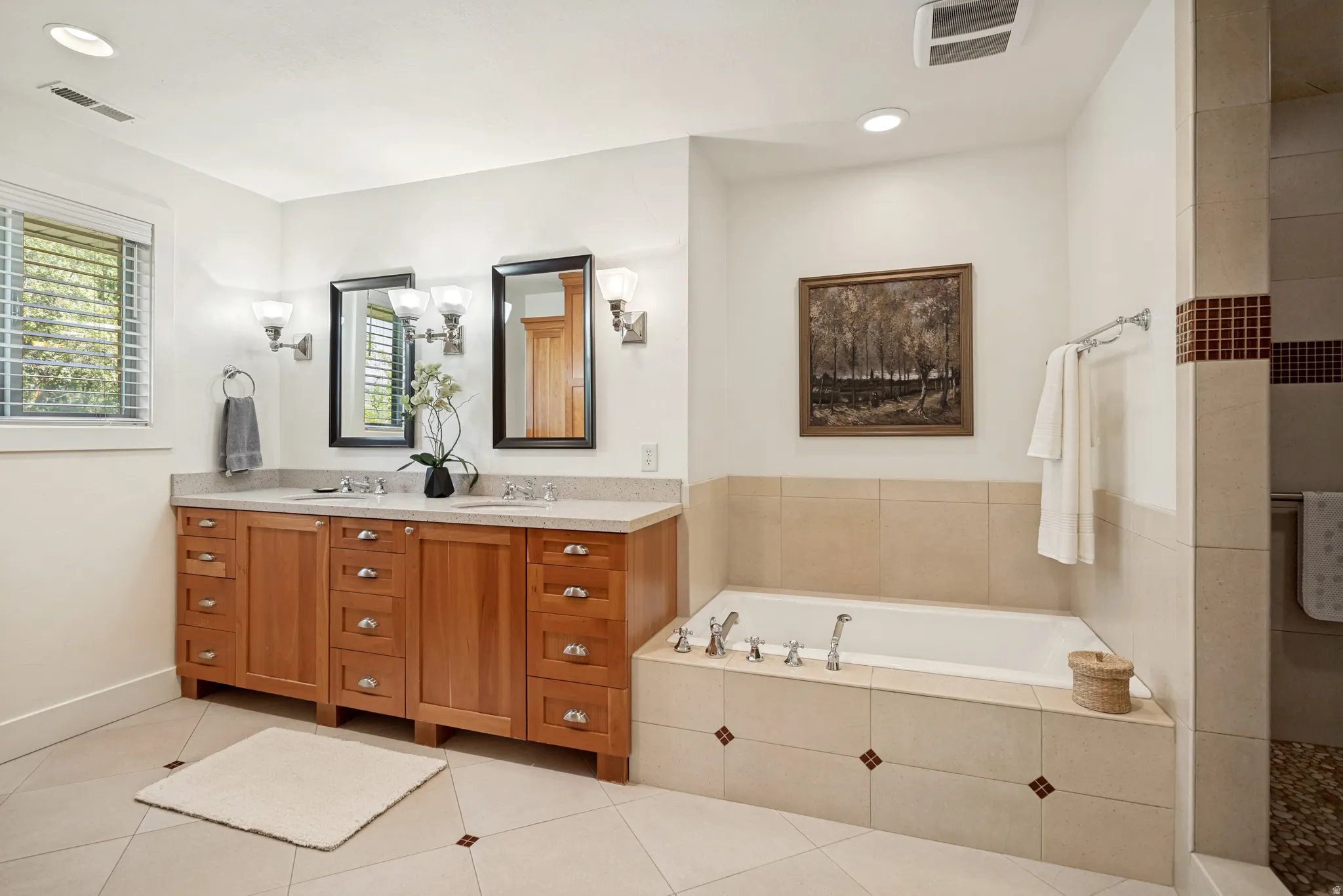 Dual vanity with wood cabinetry and undermount sinks