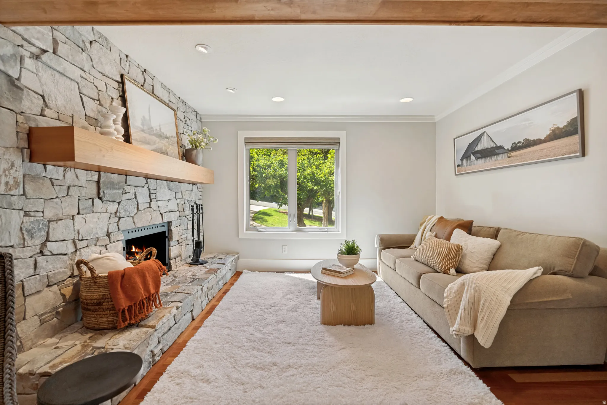 Stone fireplace with a substantial wood mantel