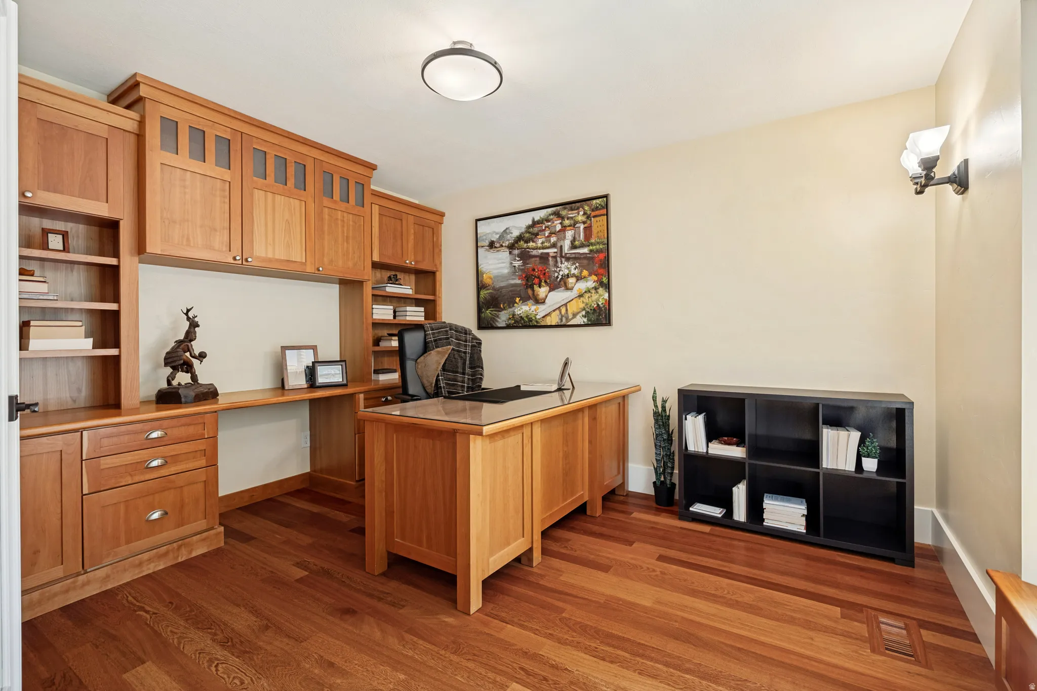 Built-in wood cabinetry with integrated shelving and desk