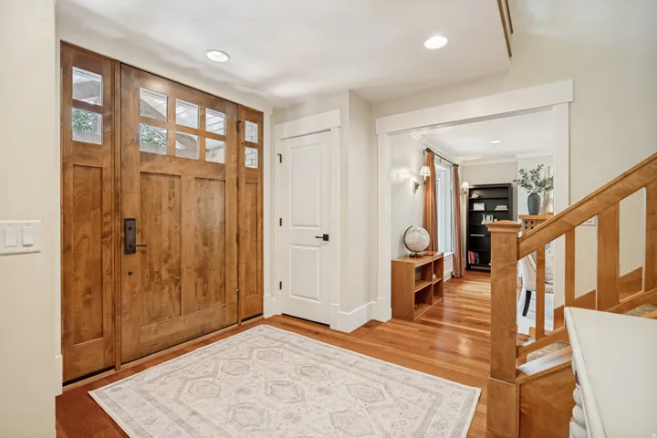 Craftsman-style front door with glass panels and sidelights