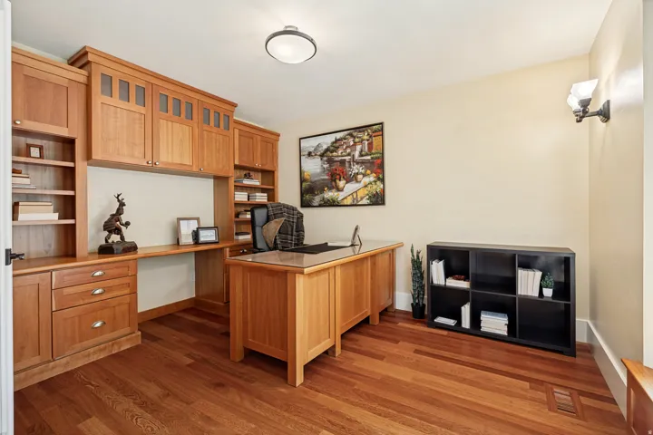 Built-in wood cabinetry with integrated shelving and desk