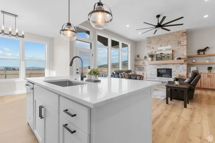 Kitchen island with integrated sink, white cabinetry, and matte black hardware