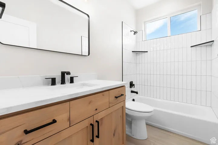Light wood-finish vanity with a white countertop and rectangular sink